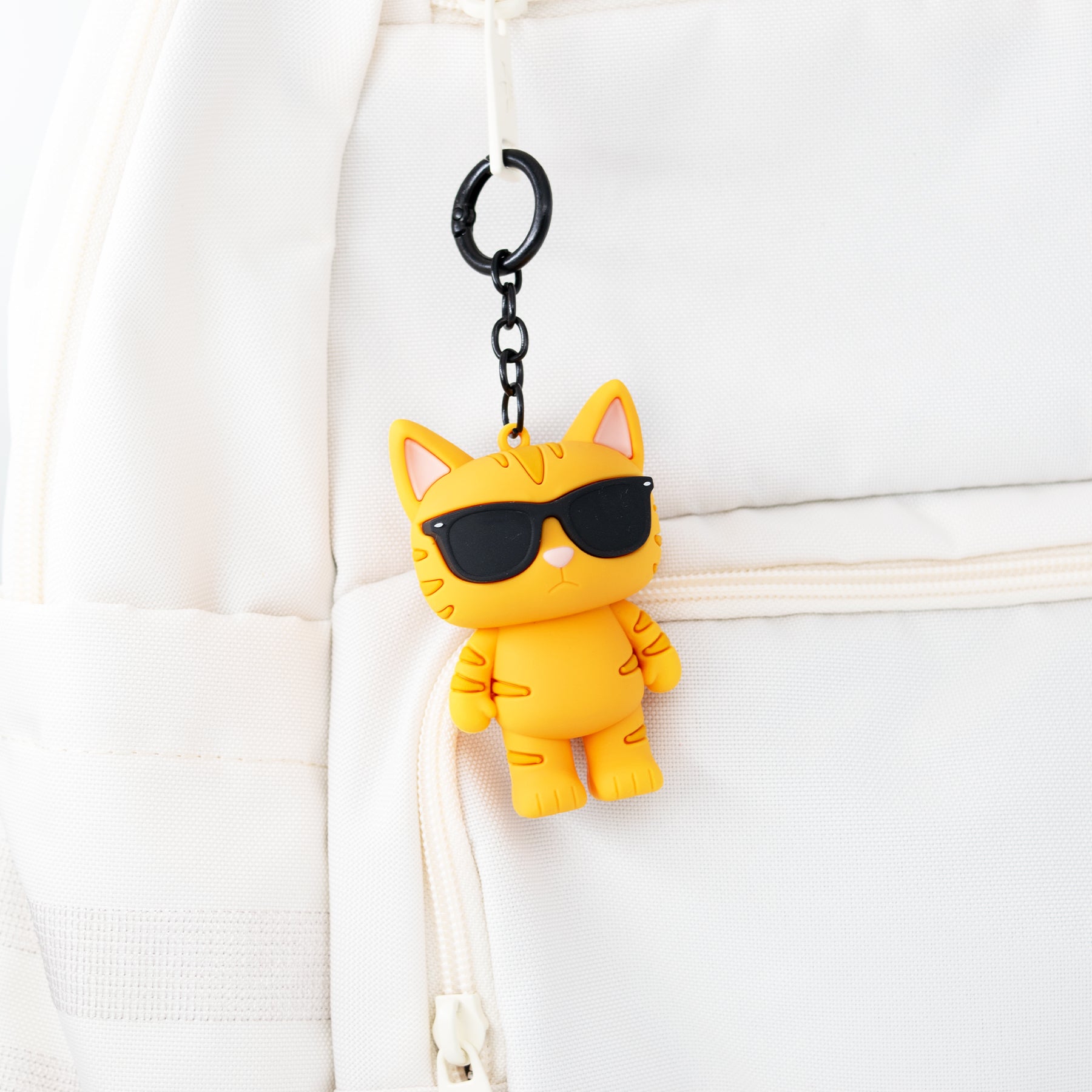 orange cat bag charm keychain on backpack