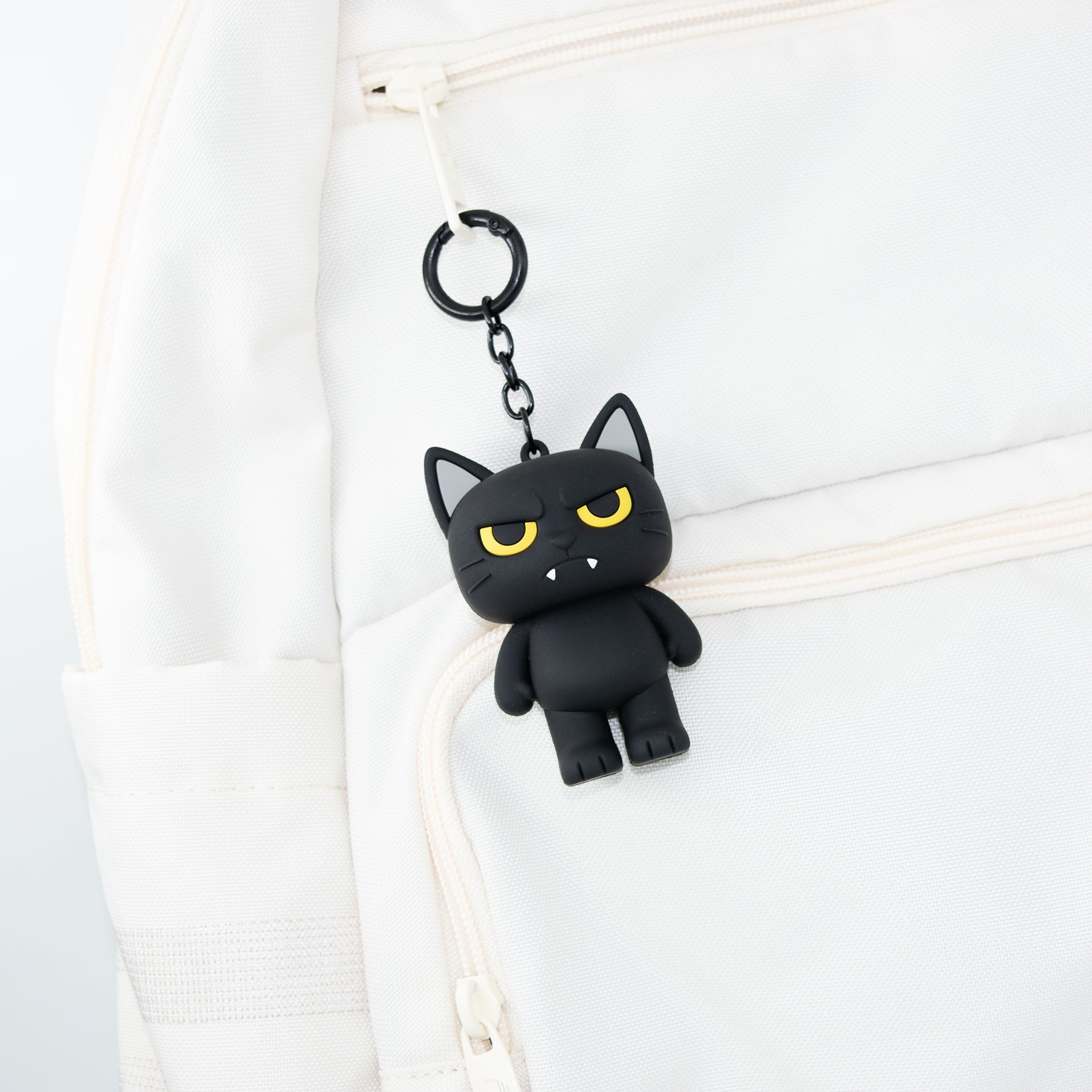 Cat charm bag charm featuring Evil Larry from TUFCAT Pocket Paws on backpack